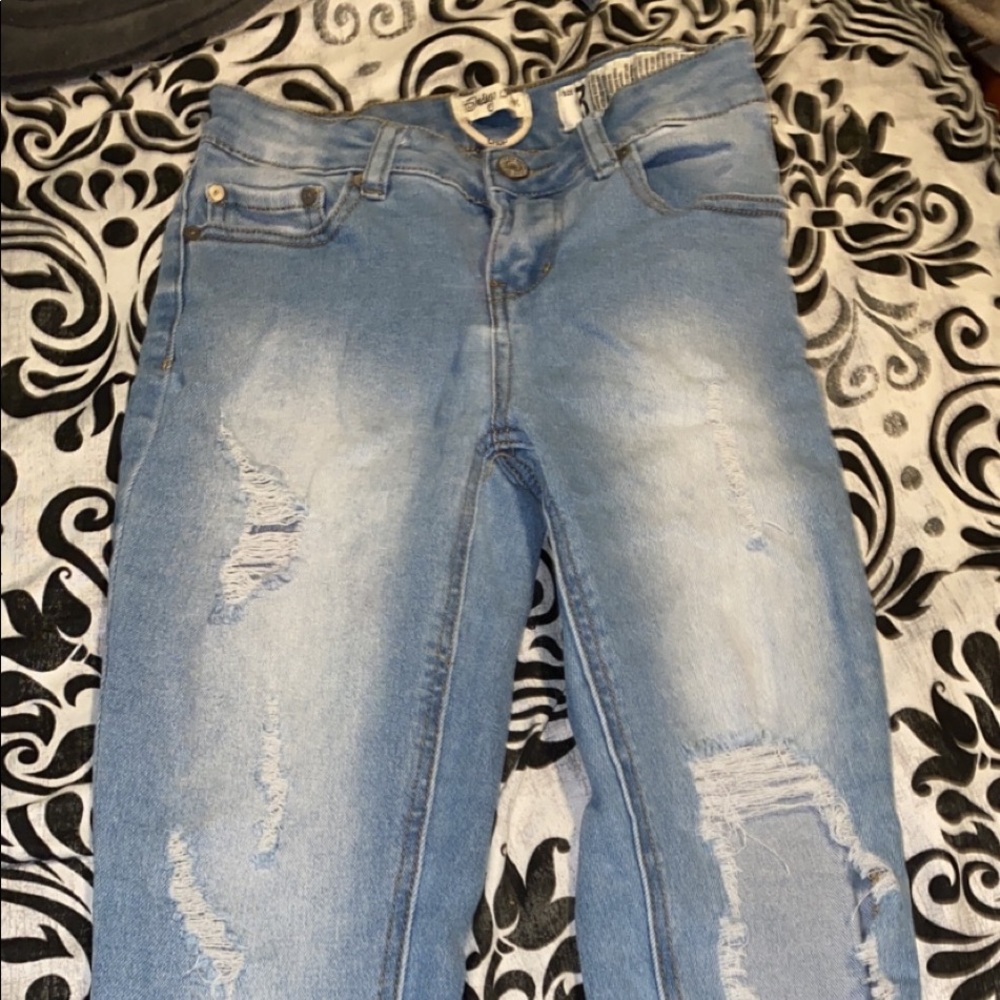 Light jeans with holes